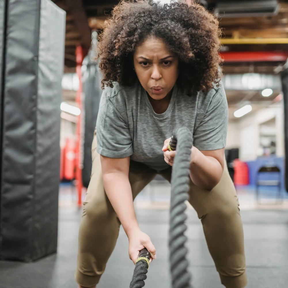 Person doing a squat as part of compound strength training.